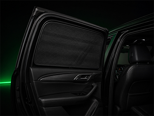 Custom-fit magnetic mesh sunshade on a car side window reducing sunlight