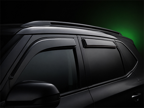 Dark smoked side window deflector rain guard installed on a car window